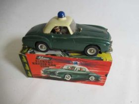 Schuco 5509 Electro Razzia battery powered Police Mercedes 190SL finished in green/white, some minor