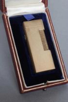 A DUNHILL 9CT GOLD ROLLAGAS CIGARETTE LIGHTER of plain oblong form with engine turning, 2 1/2" high,