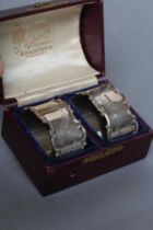 A PAIR OF GEORGE V SILVER NAPKIN RINGS, maker's mark PFM (script), Sheffield 1912, of oval form with