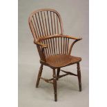 AN ASH AND ELM STICK BACK WINDSOR ARMCHAIR, Thames Valley, 19th century, with high hoop back,