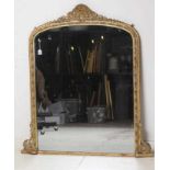A VICTORIAN GILT GESSO OVERMANTEL MIRROR, the arched plate within a moulded frame with cabochons