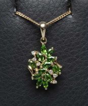A TSAVORITE GARNET AND DIAMOND ABSTRACT CLUSTER PENDANT, stamped 14k, on a 9ct gold fine chain