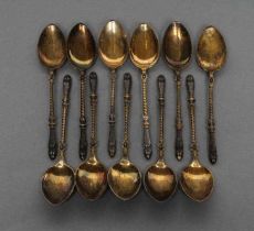 A SET OF ELEVEN TEASPOONS, 800 standard, possibly German, the finials cast as hairy cloven hooves