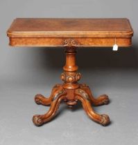 A VICTORIAN BURR WALNUT FOLDING CARD TABLE, the moulded edged rounded oblong top opening to interior