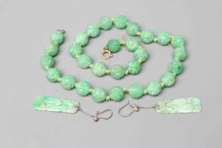 A CHINESE JADE NECKLACE, the twenty nine spherical beads carved and pierced with scrolling