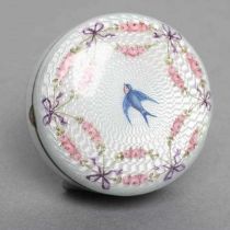 AN ENAMEL BOX AND COVER, stamped 935, of circular form painted with a bluebird within a ribbon