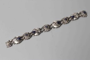 A BRACELET to match the previous lot, collet set with cabochon polished blue hardstones, stamped and