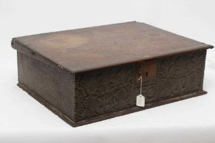 AN OAK BOARDED BOX, c.1700, the hinged lid with punched banding, the fascia carved with trailing