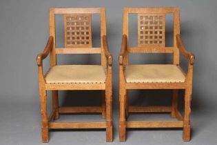 A PAIR OF PETER HEAP OAK ELBOW CHAIRS, the open lattice back with straight top rail, down swept arms