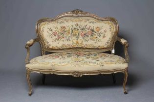 A LOUIS XV STYLE CARVED AND PAINTED CANAPE, 19th century, upholstered in floral petit point and