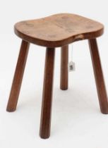 A ROBERT THOMPSON OAK STOOL, the saddle seat with carved mouse trademark in high relief to the edge,