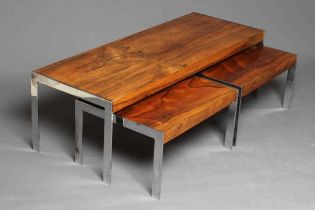 A NEST OF ROSEWOOD COFFEE TABLES, mid 20th century, of oblong form on square section chrome plated