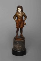 B. GRUNDMANN - An Art Deco bronze figure cast as a young boy with carved ivory face wearing a cap on