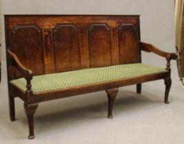 A GEORGIAN OAK SETTLE, second half 18th century, the back with straight top rail over four ogee