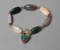 A VICTORIAN SCOTTISH PEBBLE BRACELET, the seven polished stones with unmarked metal links between