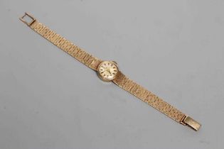 A LADY'S 9CT GOLD TISSOT WRISTWATCH, the silvered dial with applied batons, un-numbered jewelled