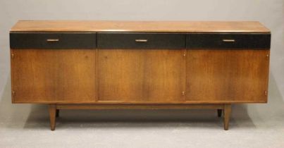 A RETRO TEAK SIDEBOARD, the moulded edged top over three black leatherette frieze drawers with