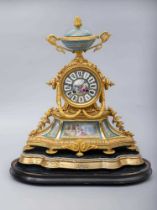 A FRENCH GILT METAL AND PORCELAIN MANTEL CLOCK, late 19th century, the twin barrel drum movement