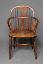 A YEW AND ELM WINDSOR ARMCHAIR, 19th century, of low hoop back form with pierced fleur de lys splat,