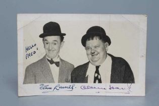 A SIGNED PHOTOGRAPH OF LAUREL AND HARDY inscribed "HELLO FRED", 5 1/2" wide (Est. plus 24% premium