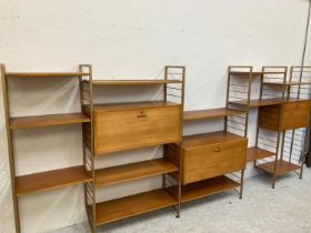 A TEAK STAPLES LADDERAX SECTIONAL MODULAR WALL UNIT in four sections raised on bronzed metal ladders