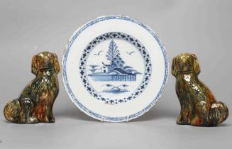 AN ENGLISH DELFT PLATE, c.1780, centrally painted in blue with a landscape with a house and two