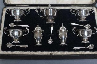 A SEVEN PIECE SILVER CRUET, maker Manoah Rhodes, London 1918, of campana form with everted gadrooned