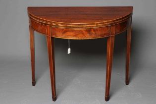 A GEORGIAN MAHOGANY TEA TABLE, late 18th century, of demi lune form crossbanded with stringing,