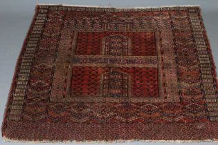 AN AFGHAN ENSI RUG, the field in two panels with candelabra motifs and central vertical elements,