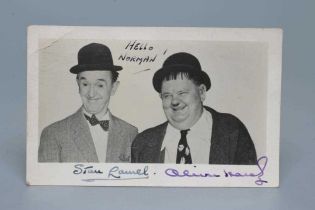 A SIGNED PHOTOGRAPH OF LAUREL AND HARDY inscribed "HELLO NORMAN", 5 1/2" wide (Est. plus 24% premium
