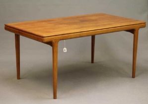 JOHANNES ANDERSEN, A DANISH TEAK EXTENDING DINING TABLE, the moulded edged rounded oblong top with