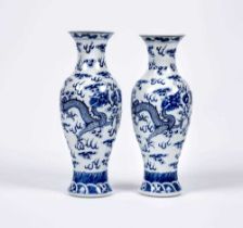 A PAIR OF CHINESE PORCELAIN VASES of inverted baluster form, painted in underglaze blue with two