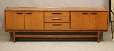 A TEAK LONG SIDEBOARD, mid 20th century, the moulded edged top over three central drawers, one