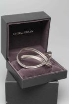 A GEORG JENSEN SILVER ALLIANCE BANGLE, numbered 554/BM., 70g, cased and boxed (Est. plus 24% premium