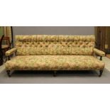 AN AESTHETIC EBONISED AND PARCEL GILT CLUB SETTEE, late 19th century, button upholstered in a floral