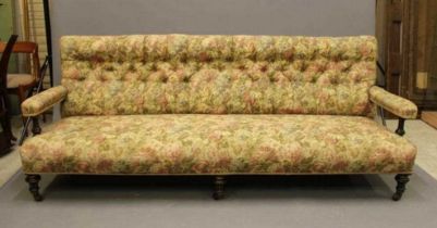 AN AESTHETIC EBONISED AND PARCEL GILT CLUB SETTEE, late 19th century, button upholstered in a floral