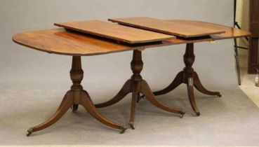 A MAHOGANY EXTENDING THREE PILLAR DINING TABLE of Georgian design, late 19th century, the reeded