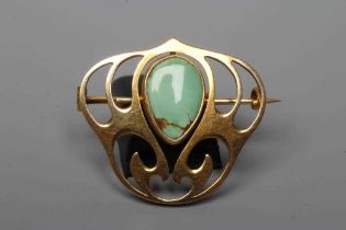 A MURRLE BENNETT BROOCH, the polished tear shaped green stone collet set to an open trefoil frame,