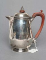 A SILVER HOT WATER JUG, maker Barraclough & Barraclough, London 1933, of rounded tapering