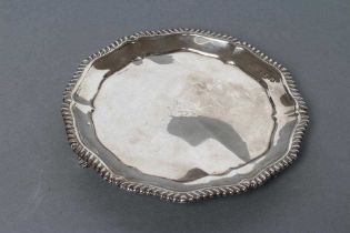 AN EARLY VICTORIAN SILVER WAITER, maker's mark rubbed, London 1838, of lobed circular form with cast