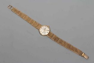 A LADY'S 9CT GOLD OMEGA WRISTWATCH, the silvered dial with gilt metal batons, the seventeen jewel