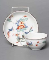 A MEISSEN PORCELAIN TEA CUP AND SAUCER, 19th century, painted in the Kakiemon palette with an exotic