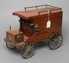 AN EDWARDIAN OAK NOVELTY SMOKERS COMPANION, modelled as a vintage car with cast brass wheels, the