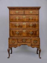 A GEORGIAN WALNUT CHEST ON STAND, mid 18th century, crossbanded with feather stringing, the