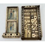 A Napoleonic prisoner of war box containing dominoes and two dice. Painted scenes to top. 15 x 8cm.