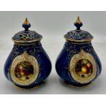 A pair of Royal Worcester pot pourri jars and covers by W. Bee with date mark for 1923. 16cm high.