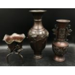 A collection of three possibly brass items to include two vases both decorated in birds along with a