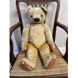 A Chad Valley 1940’s Teddy Bear with golden curly mohair, deep amber and black glass eyes, black