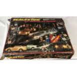A boxed Scalextric Le Mans 24 Hour along with two boxes of track and two extra power units.