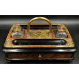 A rectangular wooden ink stand with two detachable glass inkwells, central brass carrying handle and